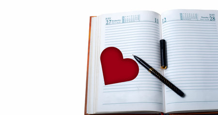 Notebook with pen and red heart on white background. Valentines day conceptの写真素材