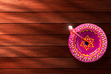Diwali diya on wooden background with space for your textの写真素材