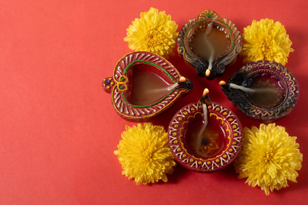 Happy Diwali and Karthika Deepa - Colorful Clay Deepams with Flowers Backgroundの写真素材