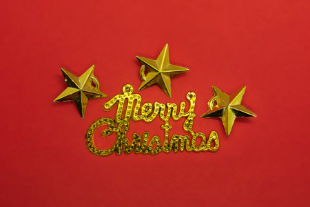 Merry Christmas card with golden stars on red background. Top viewの写真素材
