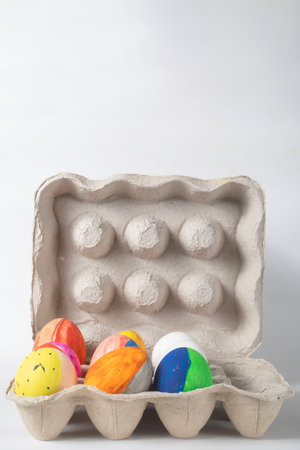 Easter eggs in a cardboard tray on a white background. Easter concept.