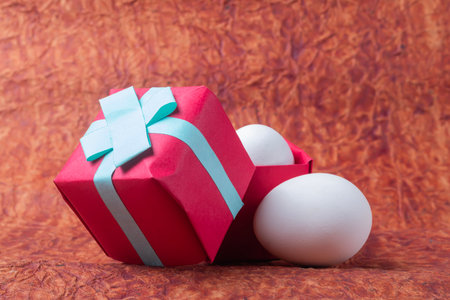 Gift boxes and white easter eggs on a background of brown paper. Happy Easter concept.の写真素材