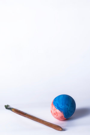 Colorful painted Easter eggs and paint brush on white background with copy spaceの写真素材