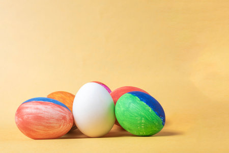 Colorful painted easter eggs on a yellow background with copy space. Happy Easter.の写真素材