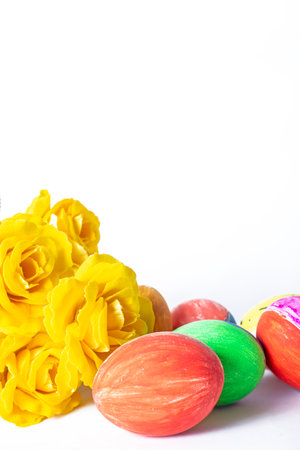 Colorful easter eggs and yellow tulips isolated on white background. Easter concept.の写真素材