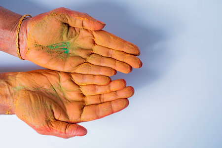 Close-up of human hand with holi powder in hand isolated on white background. Top viewの写真素材