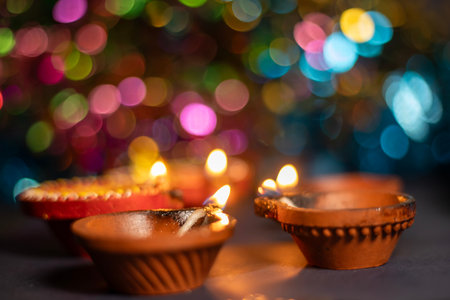 Close up of Diwali diya or lighting lamp over colorful bokeh background. Selective focusの写真素材