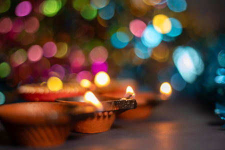 Diwali diya lamp over colourful bokeh background, Indian festival of lights. Selective focusの写真素材