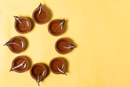 Traditional clay diya arrangement for celebration on white background. It is used during Diwali, Karthigai Deepam and other Indian festivals.の写真素材