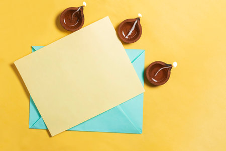 Festive Diwali greeting card with traditional clay lamps. Celebrate the festival of light with good wishes.の写真素材