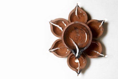 Traditional Diwali Arrangement with Earthen Diyas Forming a Floral Pattern for Festival of Lights. Top viewの写真素材