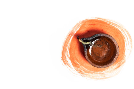 Top View of Clay Diya Lamp with Paint Stroke for Diwali Festivitiesの写真素材