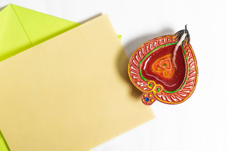 Diwali greeting card with festive diya lamp on white background.の写真素材