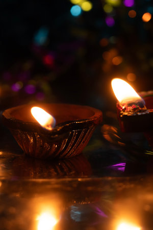 Traditional oil lamps with warm glowing flame in celebration of Diwali festival. Selective focus.