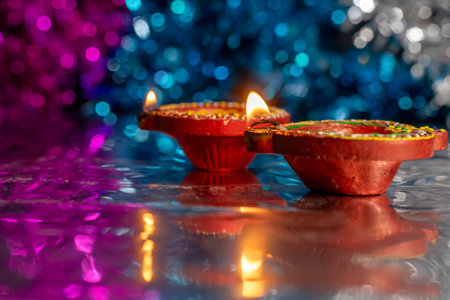 Close-up of decorated diyas during Diwali on bokeh background. Selective focus.の写真素材