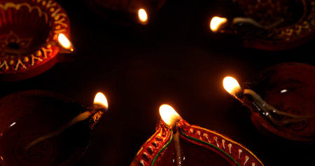 Traditional Diwali oil lamps illuminate a festive night. Diwali celebration.