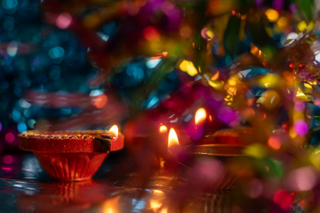 Diwali celebration background with glowing clay lamps and colorful lightsの写真素材