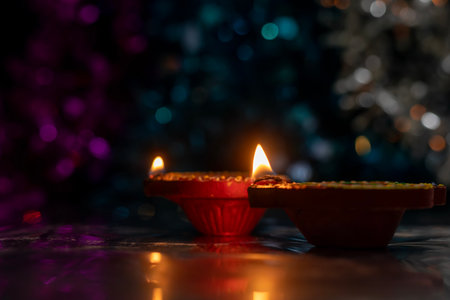 Close-up of two beautifully decorated diyas during Diwali on bokeh background. Selective focus.の写真素材