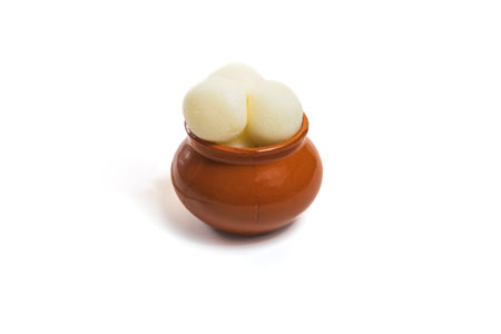 Traditional Indian rasgulla in a clay pot on white backgroundの写真素材