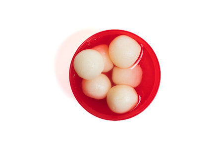 Top View of Indian Sweet Rasgulla in Red Bowl with Sugar Syrup on White Backgroundの写真素材