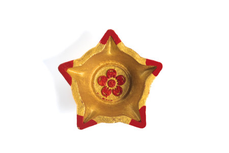 Top view of a star shaped decorative diwali oil lamp (diya) on white background