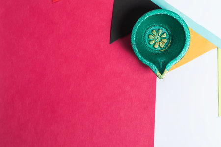 Blank Red Paper Note with Festive Diya and Decorative Flag on White Background. Diwali Celebration