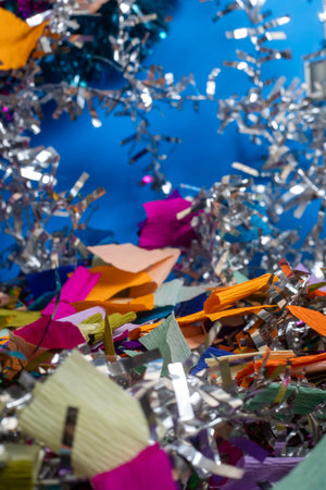 A festive and vibrant background featuring colorful confetti and shiny tinsel, perfect for celebratory events. party invitations, holiday promotions, event banners, and social media content.の写真素材