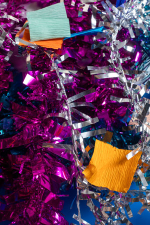 A vibrant arrangement of colorful tinsel and decorative paper, perfect for festive occasions. ideal for use in party planning, holiday promotions, event decor, and festive-themed content.の写真素材