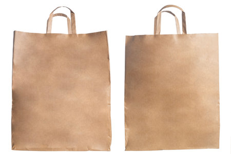 Eco-friendly brown paper bags with durable handles, perfect for shopping, gift wrapping, or packaging.の写真素材