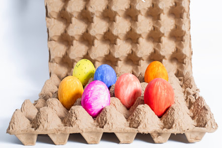 A collection of vibrant hand-painted Easter eggs in a variety of colors housed in an eco-friendly...
