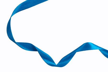 A beautiful, elegant blue satin ribbon curled on a white background, perfect for festive, decorative and promotional design concepts.の写真素材