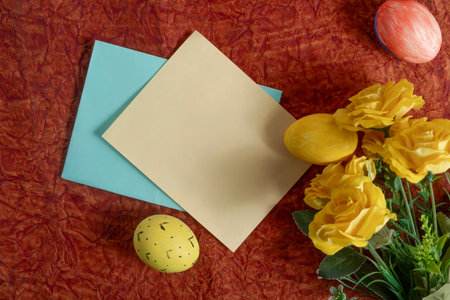 Bright yellow roses, painted Easter eggs and colorful paper placemats create a festive backdrop....