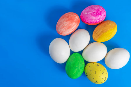 Easter eggs are creatively displayed on a blue background. Perfect for themes of celebration, spring, and cultural heritage.の写真素材