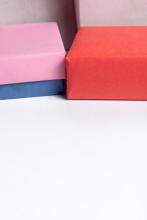 Bright, pastel gift boxes in pink, orange, and blue create a cheerful display perfect for celebrations, gifts, and holiday themes.の写真素材