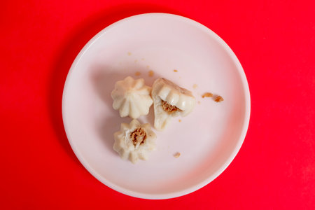 Steamed sweet modak rice dumplings arranged on white background. Perfect for Ganesh Chaturthi...