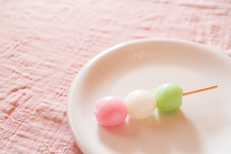 Three-colored dumplings on a white plate