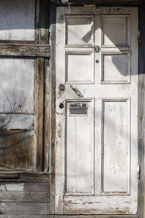 old white wooden door with post boxの写真素材
