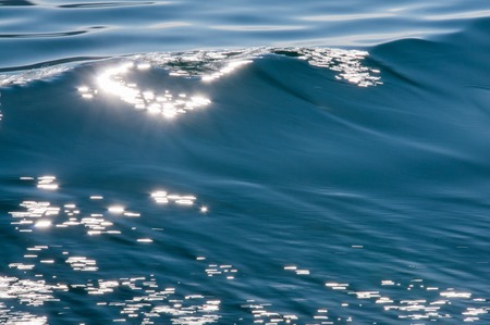Deep blue water waves for nature backgrounds with flashの写真素材