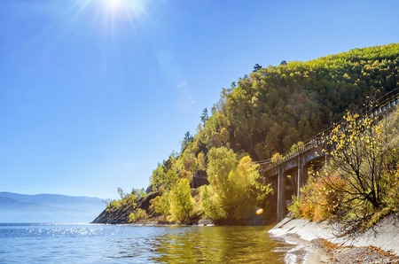 Rays of Sun in the nature with beautiful water, cost and stone bridge close to mountainの写真素材
