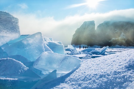 Field of blue ice and rocks with sun