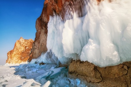 Frozen lake and rocks near the ice caveの写真素材