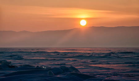 Field of ice hummocks on the frozen Lake Baikal. Sunsetの写真素材