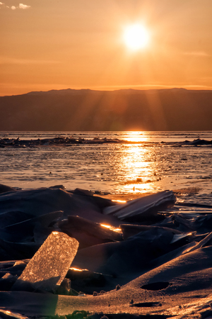 Field of ice hummocks on the frozen Lake Baikal. Sunsetの写真素材