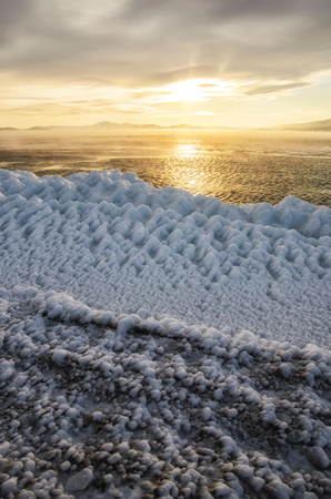 Ice floes floating on the fog water in the lake Baikal. Sunsetの写真素材