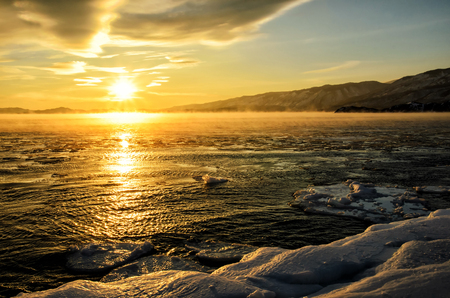 Ice floes floating on the fog water in the lake Baikal. Sunsetの写真素材