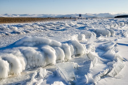 Lake Baikal in winter. Ice-covered cliffs with beautiful huge iciclesの写真素材