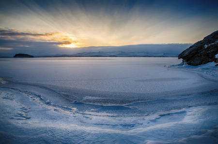 View above big beautiful frozen lake and mountain in winter, Baikal lake, Russiaの写真素材