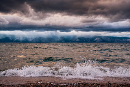 View of storm seascape with wave and mountainの写真素材