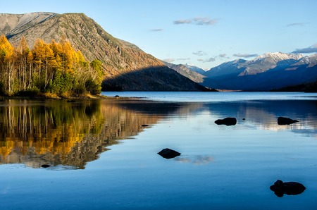 Mountain lake Froliha with stones and reflection, near lake Baikal