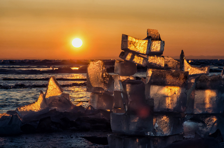 View of the ice and sunset over the mountains, lake Baikalの写真素材